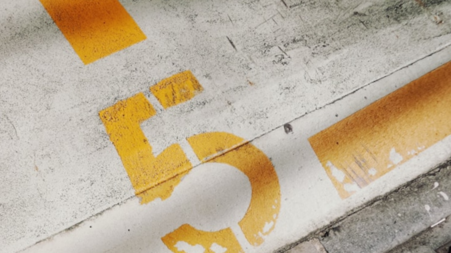 The number 5 stenciled in yellow on the ground.