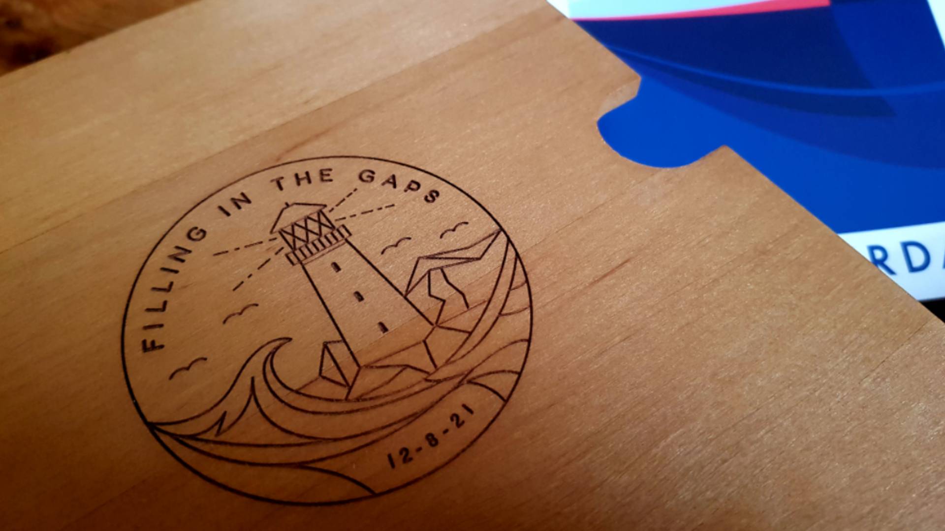 The line illustration of the lighthouse etched into a wooden box